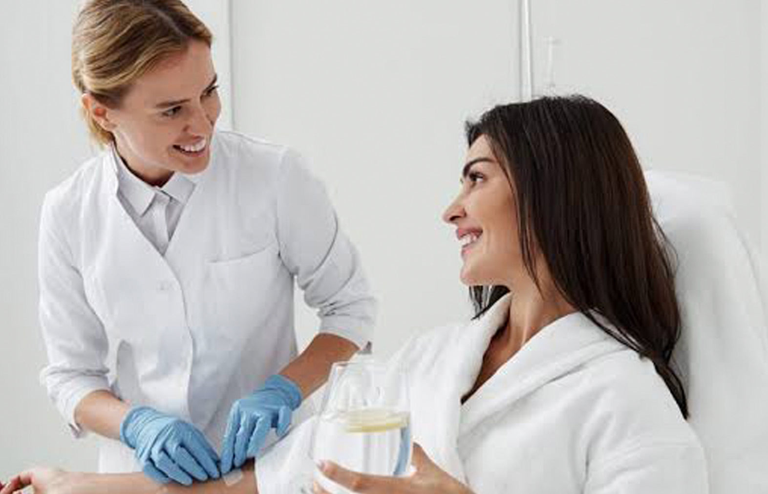 Woman receiving a skincare treatment from a professional in a clinical setting.
